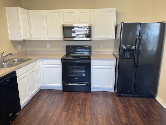 kitchen with black appliances, white cabinets, dark wood-style flooring, and a sink