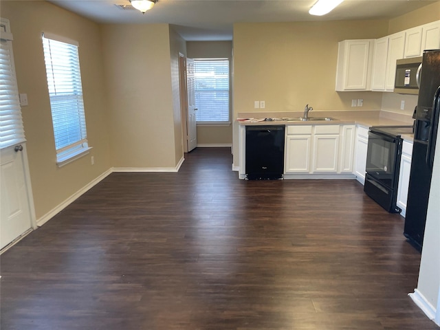 kitchen featuring black appliances, a sink, dark wood finished floors, white cabinetry, and light countertops