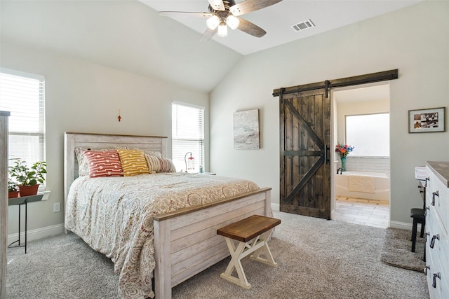 bedroom featuring visible vents, lofted ceiling, a barn door, carpet, and baseboards