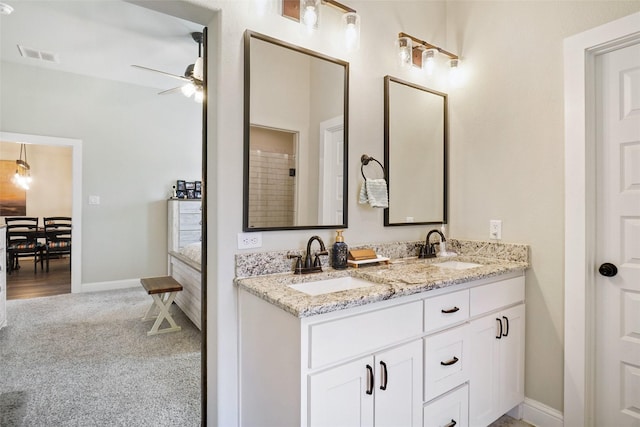 bathroom featuring double vanity, a ceiling fan, visible vents, and a sink