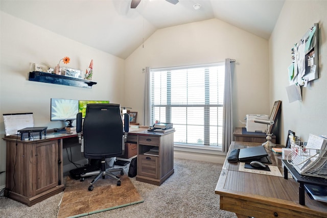 home office featuring light carpet, ceiling fan, and vaulted ceiling