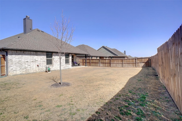 view of yard featuring a patio area and a fenced backyard