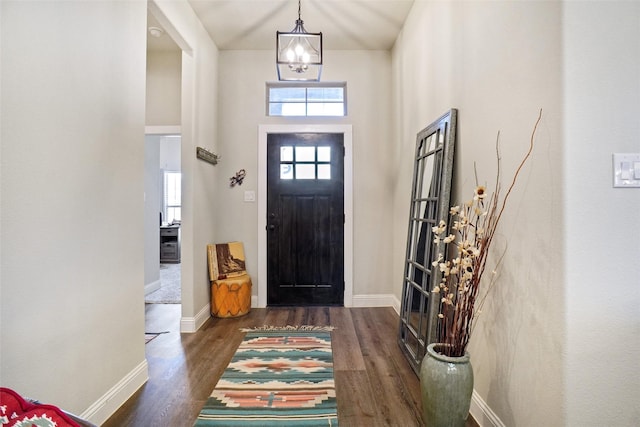 foyer entrance with baseboards and wood finished floors