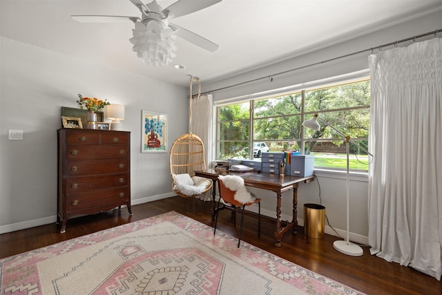 office space featuring baseboards, wood finished floors, and a ceiling fan