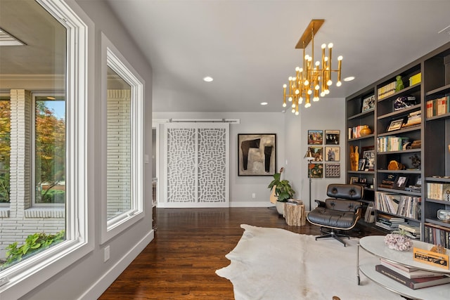 living area with recessed lighting, wood finished floors, baseboards, and a chandelier