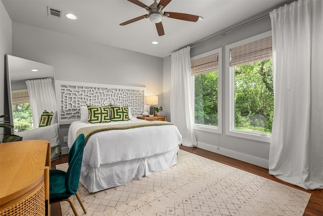 bedroom featuring recessed lighting, visible vents, baseboards, and wood finished floors