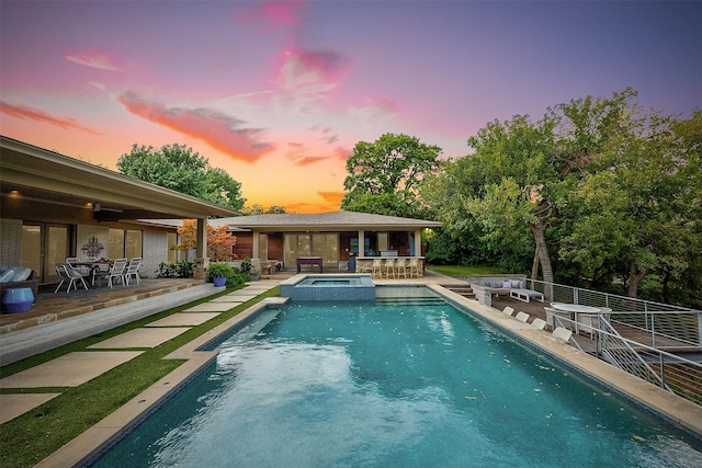 view of pool with french doors, a patio area, and a pool with connected hot tub