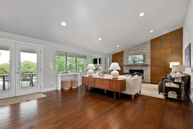 living room with vaulted ceiling, recessed lighting, a fireplace, french doors, and wood finished floors