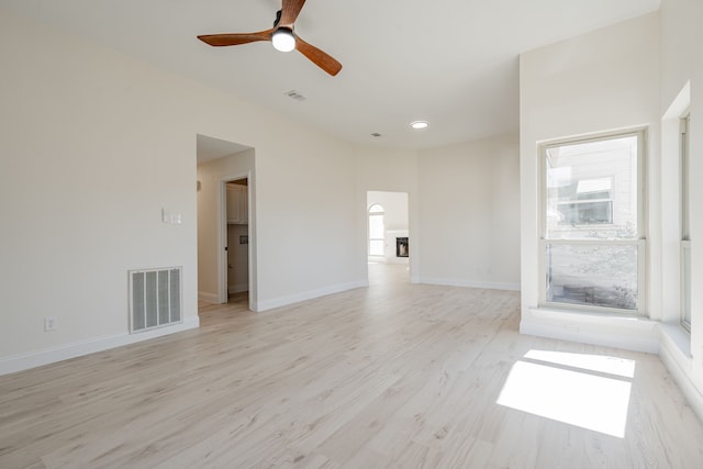 unfurnished living room featuring visible vents, baseboards, light wood-style floors, and a ceiling fan