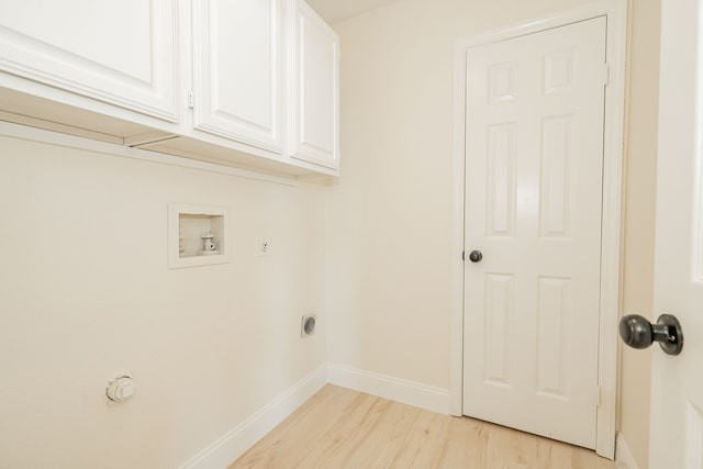 washroom featuring hookup for a gas dryer, baseboards, light wood-style floors, cabinet space, and hookup for a washing machine