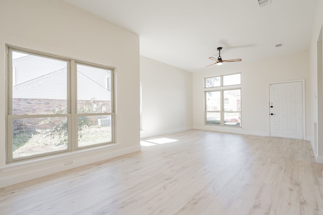 unfurnished room featuring baseboards, ceiling fan, and light wood-style flooring