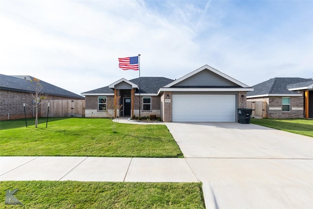 view of front of property featuring a front yard, fence, driveway, a garage, and brick siding