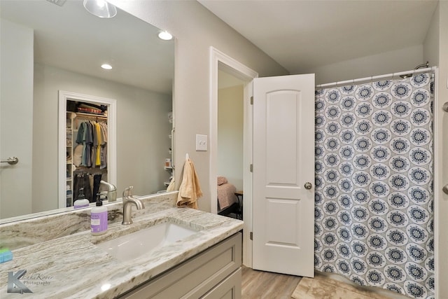 bathroom with a shower with shower curtain, recessed lighting, and vanity