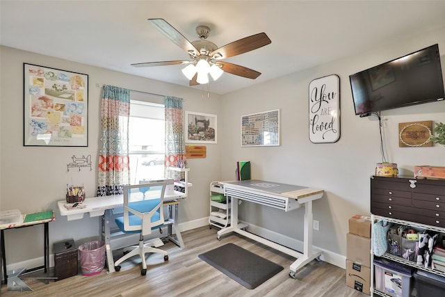 office area featuring ceiling fan, baseboards, and wood finished floors