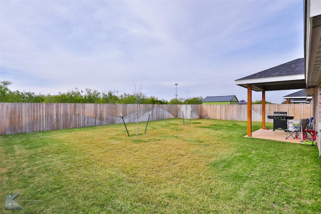 view of yard with a patio and a fenced backyard