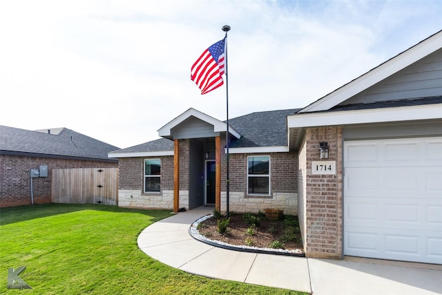 view of front of home with brick siding, a shingled roof, a front lawn, fence, and stone siding