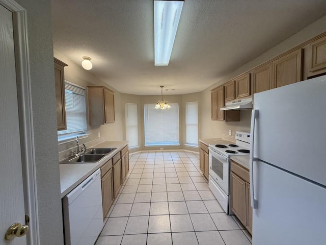 kitchen featuring under cabinet range hood, light countertops, light tile patterned flooring, white appliances, and a sink