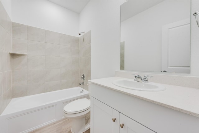 full bath with tub / shower combination, toilet, vanity, and wood finished floors