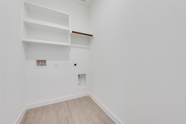 clothes washing area with baseboards, hookup for an electric dryer, laundry area, washer hookup, and light wood-type flooring