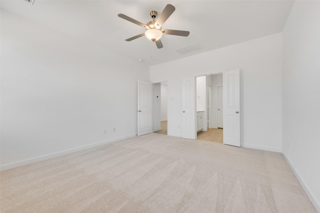 unfurnished bedroom with visible vents, baseboards, light colored carpet, and ceiling fan