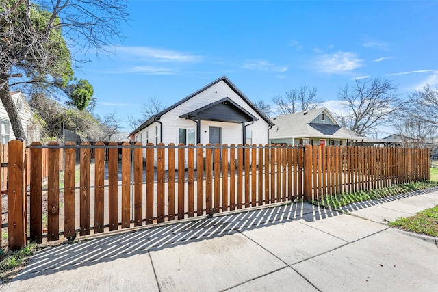 bungalow-style home featuring a fenced front yard