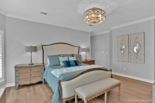 bedroom with crown molding, wood finished floors, and baseboards