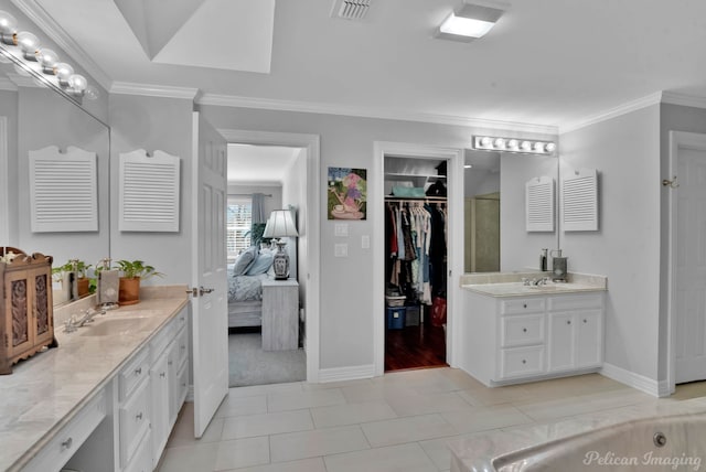 ensuite bathroom featuring a sink, visible vents, two vanities, and ornamental molding