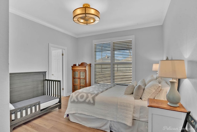 bedroom featuring ornamental molding and wood finished floors