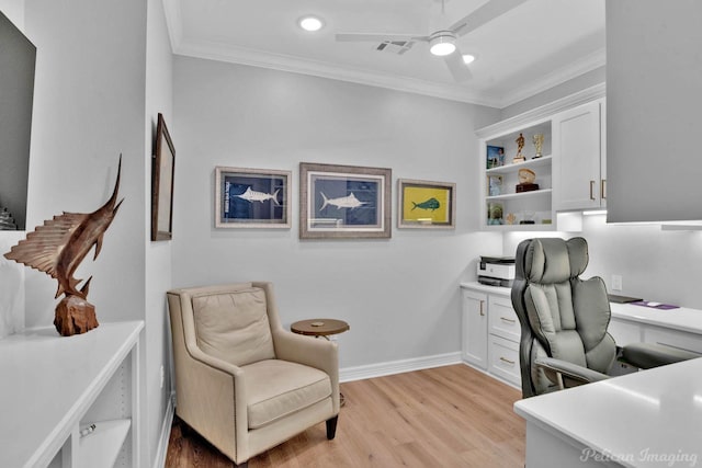 office featuring ceiling fan, light wood-style floors, visible vents, and ornamental molding