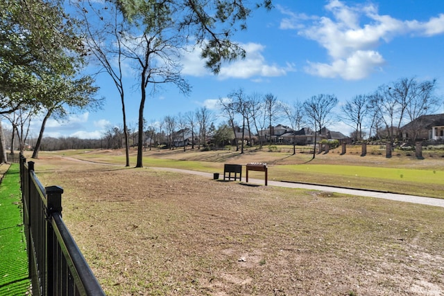 view of home's community with fence