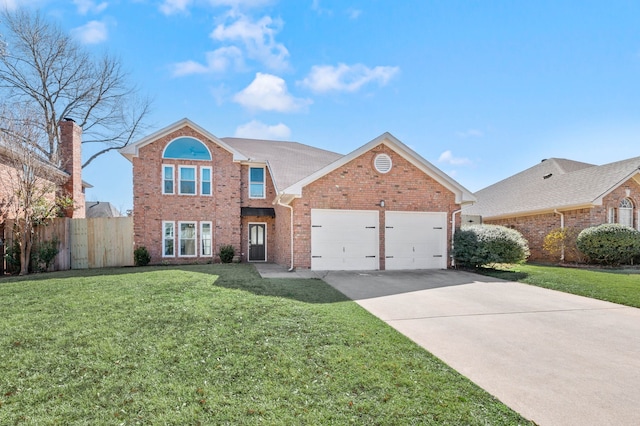 traditional-style home featuring a front yard, fence, driveway, a garage, and brick siding