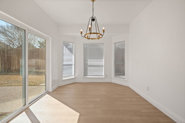 unfurnished sunroom featuring a notable chandelier