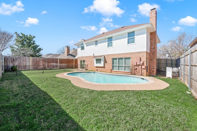 view of swimming pool featuring a lawn, a fenced backyard, and a fenced in pool