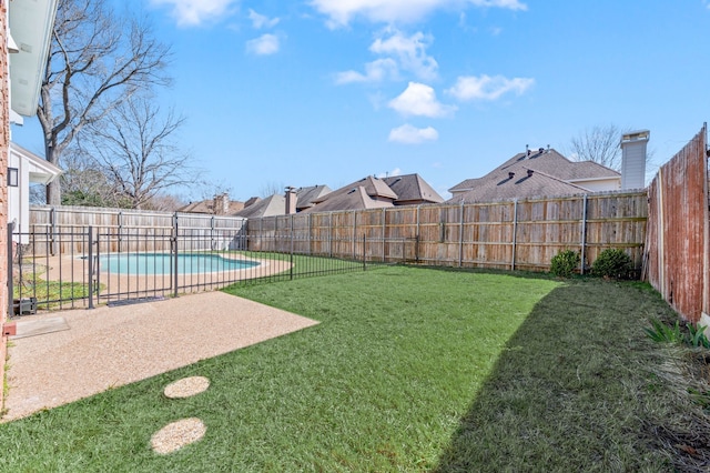 view of yard featuring a fenced in pool, a fenced backyard, and a patio area