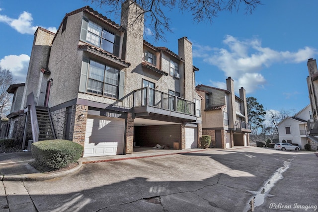 view of property with stairway and an attached garage