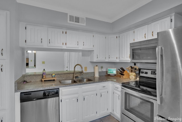 kitchen featuring a sink, visible vents, white cabinetry, and stainless steel appliances