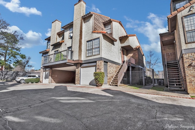 view of property with stairway and a garage