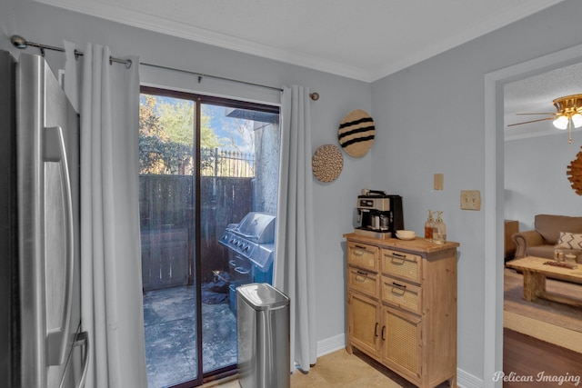 doorway with baseboards, ornamental molding, and a ceiling fan