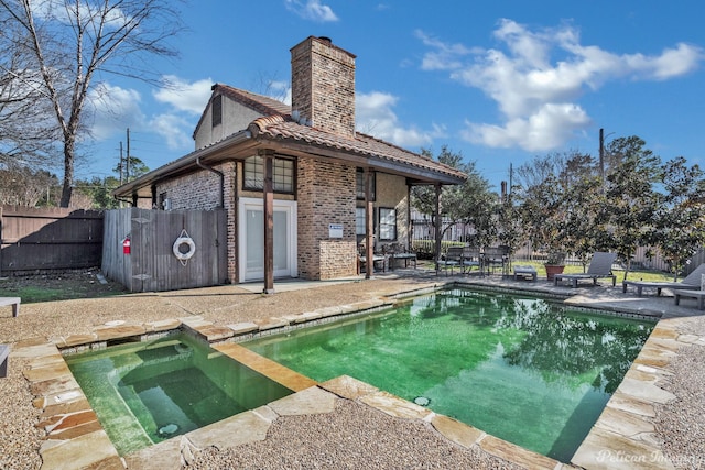 view of pool with a patio area, a fenced in pool, an in ground hot tub, and a fenced backyard