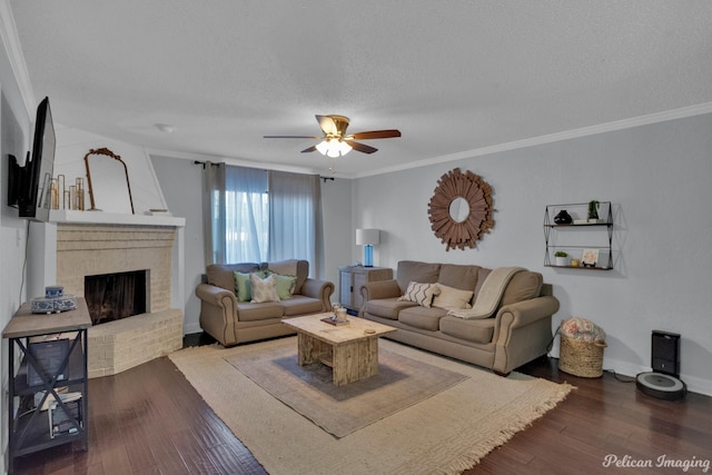 living room featuring a fireplace, a textured ceiling, crown molding, and wood finished floors