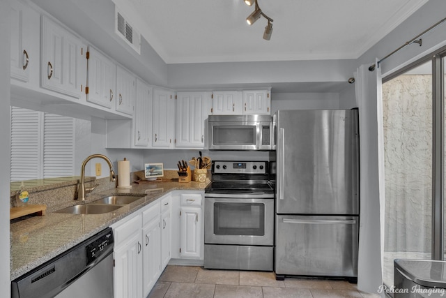 kitchen with visible vents, a sink, stainless steel appliances, white cabinets, and light stone countertops