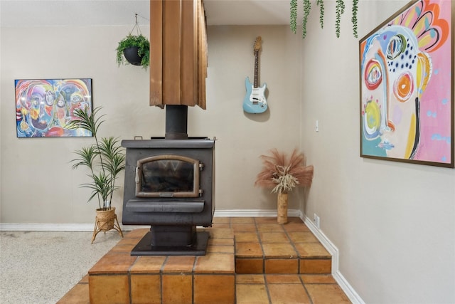 interior details featuring a wood stove and baseboards