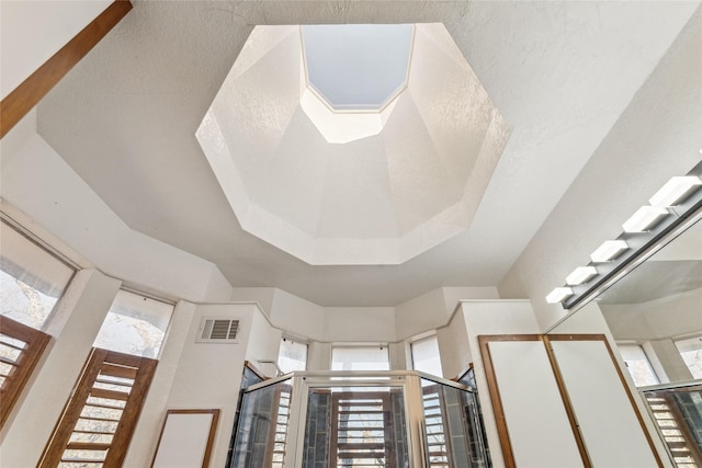 room details featuring visible vents and a raised ceiling