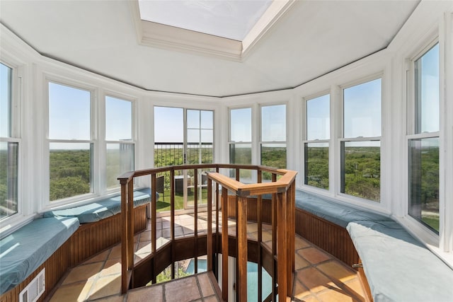 sunroom / solarium with ornamental molding, visible vents, and a tray ceiling