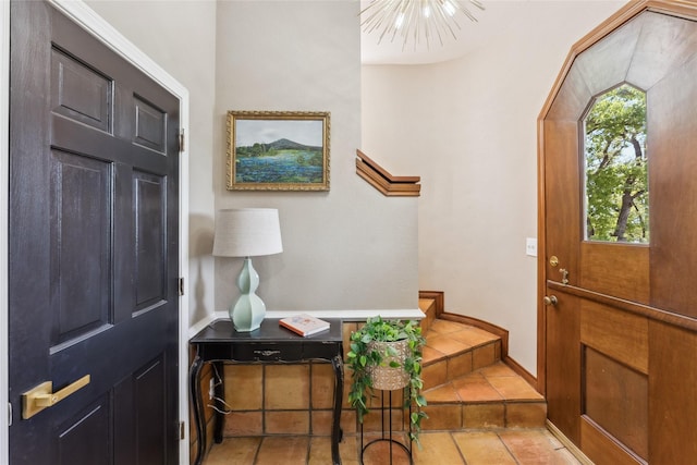 foyer entrance featuring tile patterned floors and baseboards