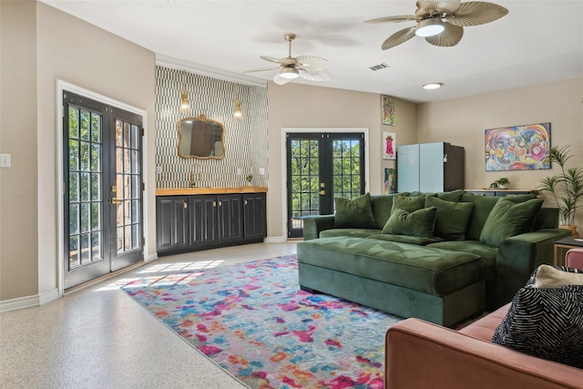 living room with french doors, baseboards, visible vents, and a healthy amount of sunlight