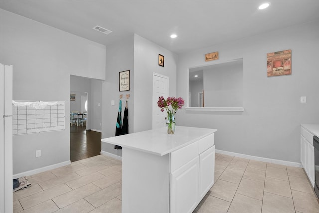 kitchen with visible vents, baseboards, light countertops, recessed lighting, and white cabinets