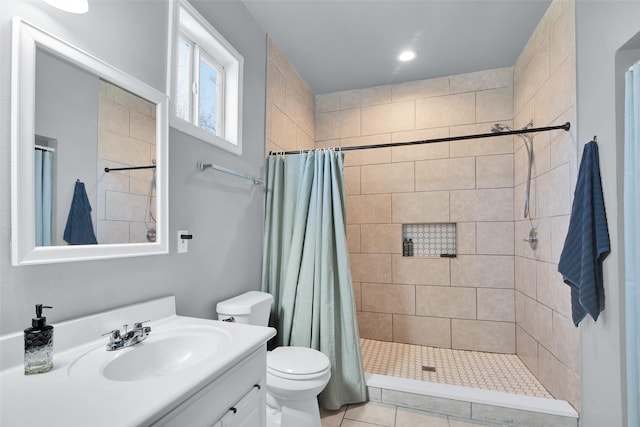 full bath with toilet, a stall shower, and vanity