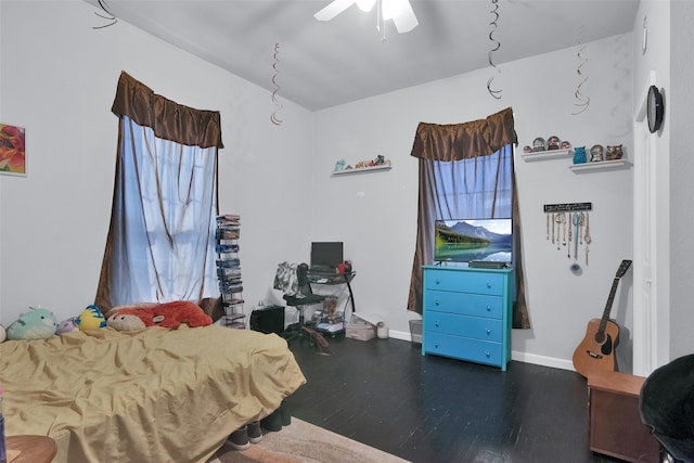 bedroom featuring a ceiling fan, wood finished floors, and baseboards