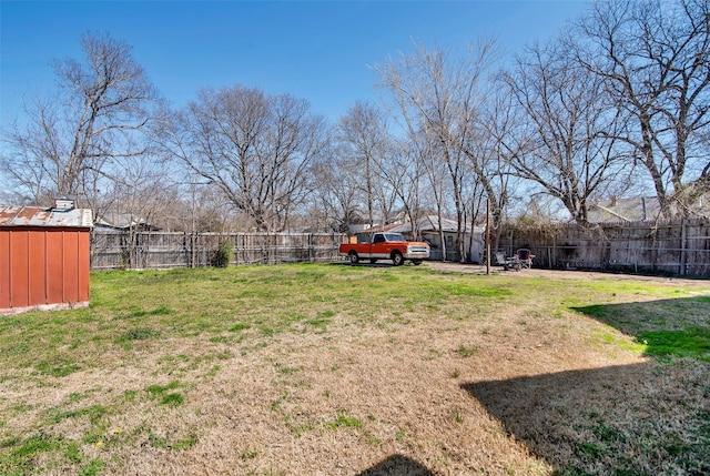 view of yard with an outbuilding and a fenced backyard